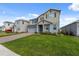 Two-story home with lush green lawn, brick-paver driveway, and neutral color scheme at 1171 Lone Palm Way, St Cloud, FL 34771