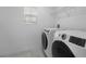 Functional laundry room featuring modern, front-load washer and dryer, plus plenty of space at 1171 Lone Palm Way, St Cloud, FL 34771