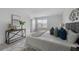 Comfortable main bedroom with a gray upholstered headboard, plush rug, and neutral decor at 1171 Lone Palm Way, St Cloud, FL 34771