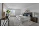 Neutral main bedroom with a gray upholstered headboard, plush rug, and decorative art at 1171 Lone Palm Way, St Cloud, FL 34771