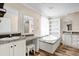 Bright bathroom featuring double sinks, and a corner soaking tub at 11811 Kijik Trl, Groveland, FL 34736