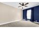 Bedroom with neutral walls, carpet flooring and a ceiling fan, lit by natural light coming in from the window at 11811 Kijik Trl, Groveland, FL 34736