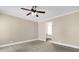 Bedroom with beige walls, ceiling fan and carpeted floors at 11811 Kijik Trl, Groveland, FL 34736