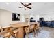 Dining room with wooden table and chairs situated near the kitchen; a modern horse painting hangs on the wall at 11811 Kijik Trl, Groveland, FL 34736