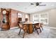 Dining area with wooden table and chairs, a grandfather clock and a rustic brick accent wall enhance the room's charm at 11811 Kijik Trl, Groveland, FL 34736