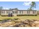 A charming single-story home with vinyl siding and a manicured lawn at 11811 Kijik Trl, Groveland, FL 34736