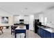 Bright kitchen featuring white upper cabinets and bold navy blue lower cabinets, stainless steel appliances and island seating at 11811 Kijik Trl, Groveland, FL 34736