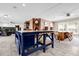 Spacious living room featuring a brick accent wall with built-in shelving, adjacent to the dining area at 11811 Kijik Trl, Groveland, FL 34736