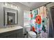 Well-lit bathroom features tile shower and modern vanity at 12419 Eryn Ct, Clermont, FL 34711