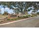 A brick sign marks the entrance to The Oranges community at 12419 Eryn Ct, Clermont, FL 34711