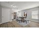 A dining room is staged with seating for six and features wood-look floors and neutral paint at 12419 Eryn Ct, Clermont, FL 34711