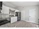 Well-lit kitchen highlighting stylish floors, stainless steel appliances, and a door at 12419 Eryn Ct, Clermont, FL 34711