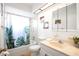 Bright bathroom featuring a shower-tub combo, modern vanity, and white walls, creating a clean and inviting space at 1244 Spinnaker Dr, Lakeland, FL 33805