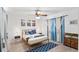 Well-lit bedroom with blue and white bedding, matching bedside tables and a ceiling fan at 1244 Spinnaker Dr, Lakeland, FL 33805