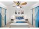 Bedroom with a ceiling fan, cool-toned art and patterned curtains at 1244 Spinnaker Dr, Lakeland, FL 33805