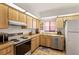 Kitchen showcasing wood cabinets, a stainless steel sink, and colorful floor tiles at 1244 Spinnaker Dr, Lakeland, FL 33805