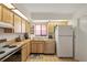 Kitchen featuring wood cabinets, a stainless steel sink, and colorful floor tiles at 1244 Spinnaker Dr, Lakeland, FL 33805