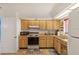 Functional kitchen with wood cabinetry, stainless steel appliances and tiled floor at 1244 Spinnaker Dr, Lakeland, FL 33805