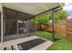 Screened back porch overlooking a grassy, fenced yard with mature trees at 1269 Winter Green Way, Winter Garden, FL 34787