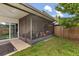 Screened back porch leads to a grassy yard with wood privacy fence at 1269 Winter Green Way, Winter Garden, FL 34787