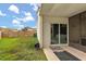 View of the back yard from the porch, with sliding door to the interior at 1269 Winter Green Way, Winter Garden, FL 34787