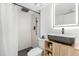 Modern bathroom with a sleek black sink, wood-look vanity, walk-in shower, and LED mirror at 1269 Winter Green Way, Winter Garden, FL 34787