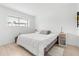 Bright bedroom with light wood floors, neutral walls, and a large window at 1269 Winter Green Way, Winter Garden, FL 34787