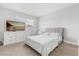 Bright bedroom featuring a plush bed, white dresser with TV, and large window at 1269 Winter Green Way, Winter Garden, FL 34787