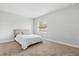 Minimalist bedroom with a full-size bed, carpeted flooring, and natural light from the window at 1269 Winter Green Way, Winter Garden, FL 34787