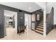 Inviting entryway and staircase adjacent to an open kitchen with stainless steel appliances at 1269 Winter Green Way, Winter Garden, FL 34787