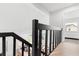 Second floor hallway with dark wood bannister overlooking the living room at 1269 Winter Green Way, Winter Garden, FL 34787