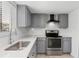 Well-lit kitchen featuring modern stainless-steel appliances and gray cabinetry at 1269 Winter Green Way, Winter Garden, FL 34787