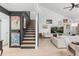 Open floor plan living area with neutral tones and modern design, staircase leading to the second floor at 1269 Winter Green Way, Winter Garden, FL 34787