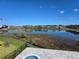 Beautiful lakefront backyard view with lush greenery and private pool, perfect for outdoor living at 13217 Tollcross Way, Winter Garden, FL 34787