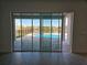 Expansive glass doors offer views of the pool, lake, and manicured backyard at 13217 Tollcross Way, Winter Garden, FL 34787