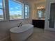 Bright bathroom with tub, vanity, and ample natural light at 13217 Tollcross Way, Winter Garden, FL 34787