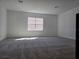 Carpeted bedroom with a large window providing natural light at 13217 Tollcross Way, Winter Garden, FL 34787