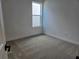 Empty bedroom space featuring carpet and a window offering natural light at 13217 Tollcross Way, Winter Garden, FL 34787