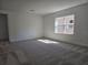 Carpeted bedroom with a large window providing natural light at 13217 Tollcross Way, Winter Garden, FL 34787