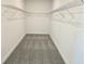 Walk-in closet featuring carpeted floors, metal shelving and white walls at 13217 Tollcross Way, Winter Garden, FL 34787