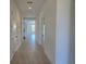 Bright hallway featuring tile flooring, white walls, and a view into the main living area at 13217 Tollcross Way, Winter Garden, FL 34787