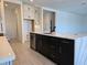 Modern kitchen features a large island with quartz countertops and dark cabinetry at 13217 Tollcross Way, Winter Garden, FL 34787