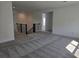 Spacious carpeted living room with white walls and access to the upstairs at 13217 Tollcross Way, Winter Garden, FL 34787