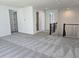 Spacious carpeted living room with white walls and entryways at 13217 Tollcross Way, Winter Garden, FL 34787