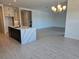 Open-concept living area with tile floors, a chandelier, and easy access to kitchen at 13217 Tollcross Way, Winter Garden, FL 34787