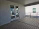 View of the outdoor patio with white framed doors and black railing, perfect for enjoying the weather at 13217 Tollcross Way, Winter Garden, FL 34787