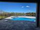 Backyard pool area with fenced-in pool, spa, and serene water views at 13217 Tollcross Way, Winter Garden, FL 34787