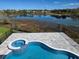 Aerial view of the uniquely shaped private pool and spa overlooking a tranquil lake at 13217 Tollcross Way, Winter Garden, FL 34787