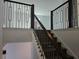 Staircase featuring ornamental metal railing and dark wood steps and landing at 13217 Tollcross Way, Winter Garden, FL 34787