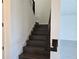 Dark-stained staircase with white trim and walls leading to an upstairs landing at 13217 Tollcross Way, Winter Garden, FL 34787